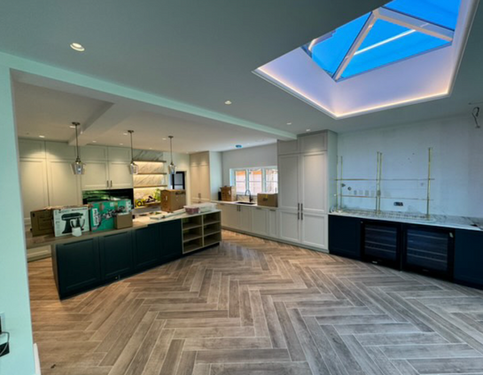 **Image 1**: Abstract geometric shapes in blue and gray.
**Image 2**: Modern kitchen with herringbone floor and skylight.