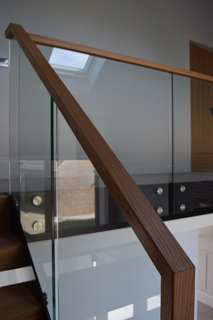 Glass and wood staircase with metal accents.