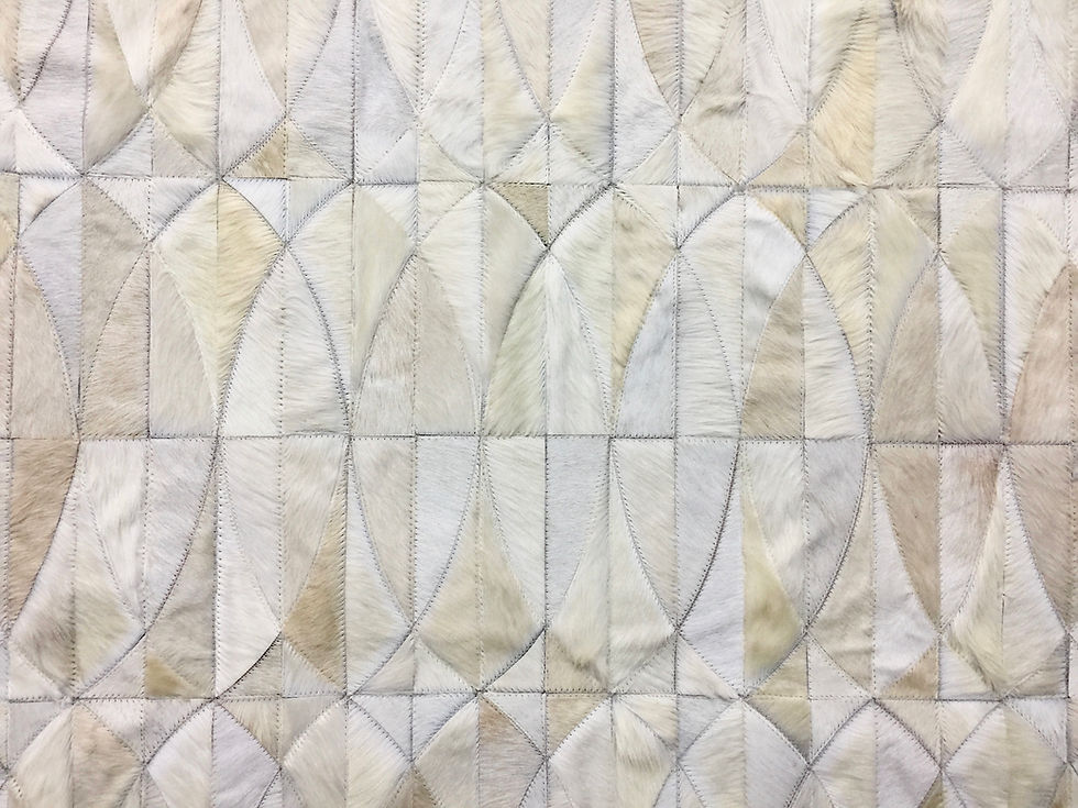 Thumbnail: Lobos hide rug in a custom layout on a modern living room floor, handmade luxury cowhide rug by Lifestyle by Cara