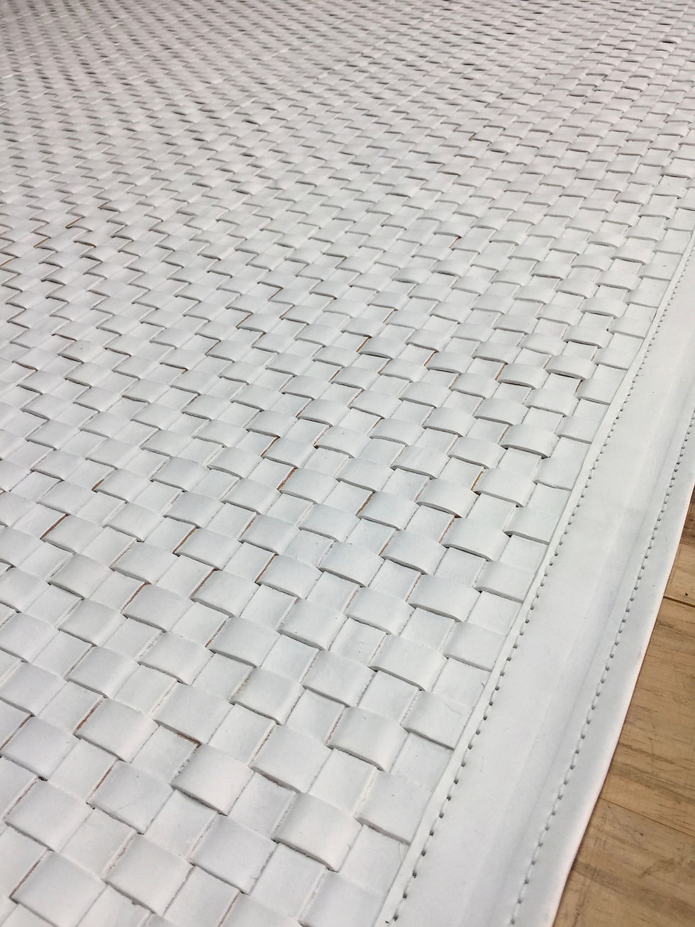 Thumbnail: Guemes woven saddle‑leather rug in white with leather border on a modern living room floor, handmade luxury rug by Lifestyle