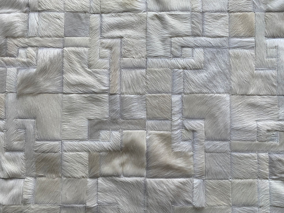 Thumbnail: Pergamino cowhide patchwork rug with stepped‑border, maze‑like pattern on the floor