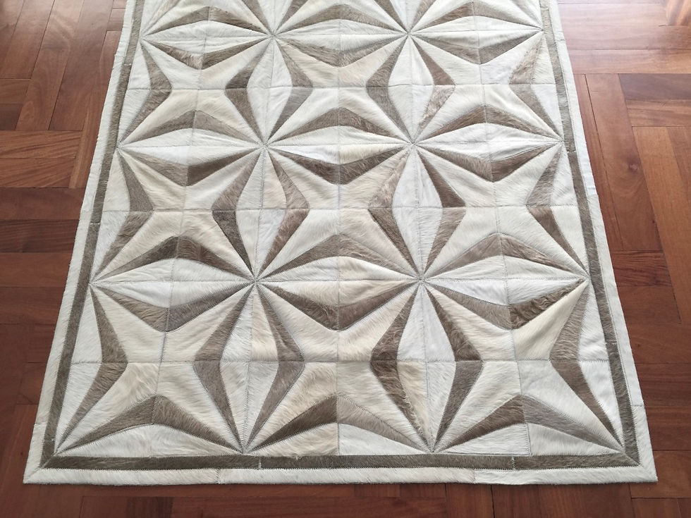 Thumbnail: Close-up of Pellegrini hide rug showing geometric dimensional star pattern