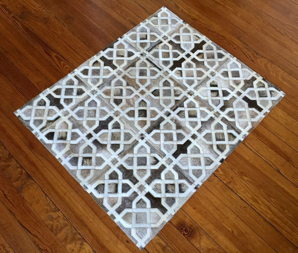 Thumbnail: Carilo hide rug in taupes, off white, and muted greys on a modern living room floor, handmade luxury contemporary cowhide rug