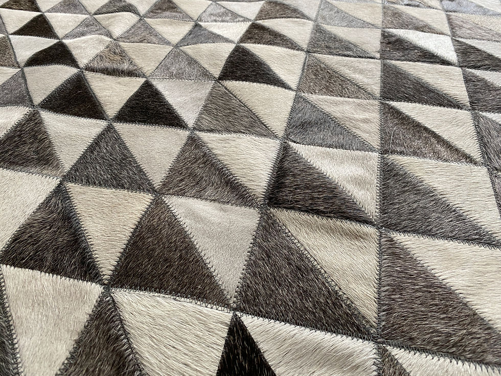 Thumbnail: Pilar cowhide patchwork rug with crisp grid of small squares and linear bands on the floor