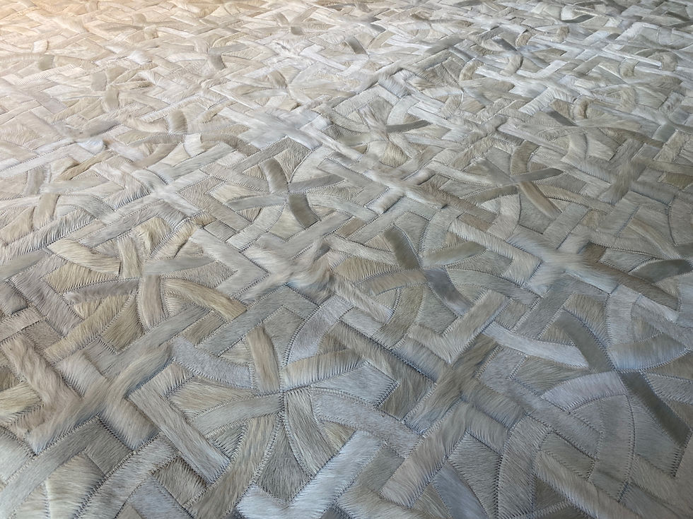 Thumbnail: Tilcara hide rug in 9 x 9 inch panels of grey brown, off white, and mixed greys on a modern living room floor, handmade cowhi