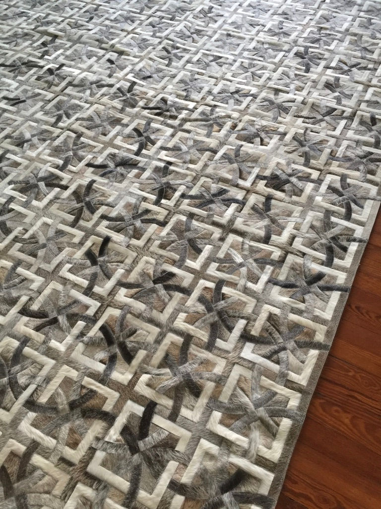 Thumbnail: Tilcara cowhide rug styled in a light, airy living room next to a neutral sofa, warm, whimsical hide floor rug