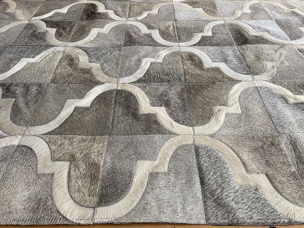 Thumbnail: San Cristobal hair‑on cowhide rug with a tight, repeating pattern of small hides and soft geometric lines on a light floor in