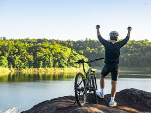 yoga teacher celebrating with happiness his bike ride