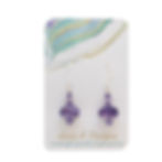 purple swirl lampwork earrings on an earring card
