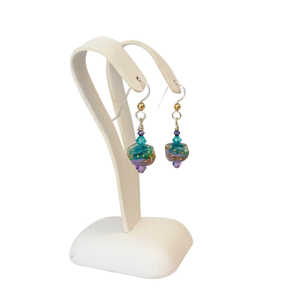 purple and aqua lampwork bead earrings on an earring display