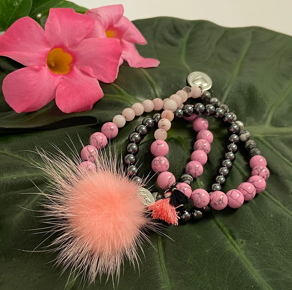Thumbnail: gemstone bracelet set on a tropical leaf near Mandevilla flowers