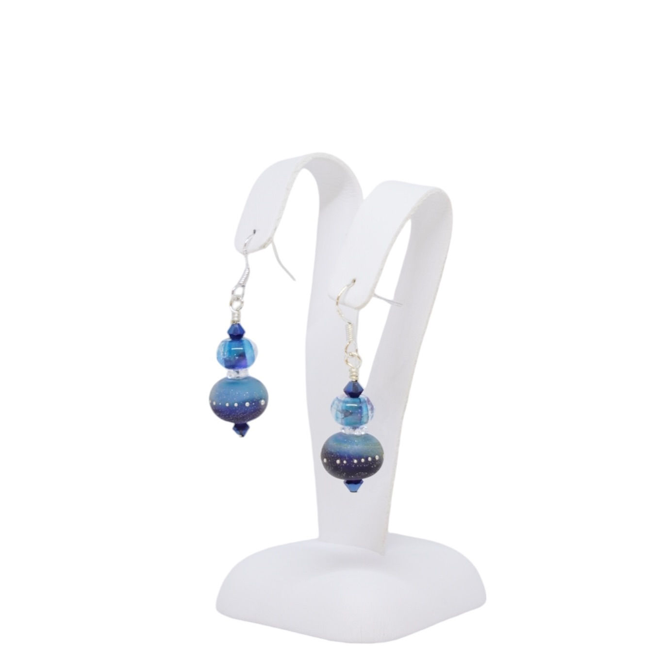 Blue lampwork bead earrings on earring display
