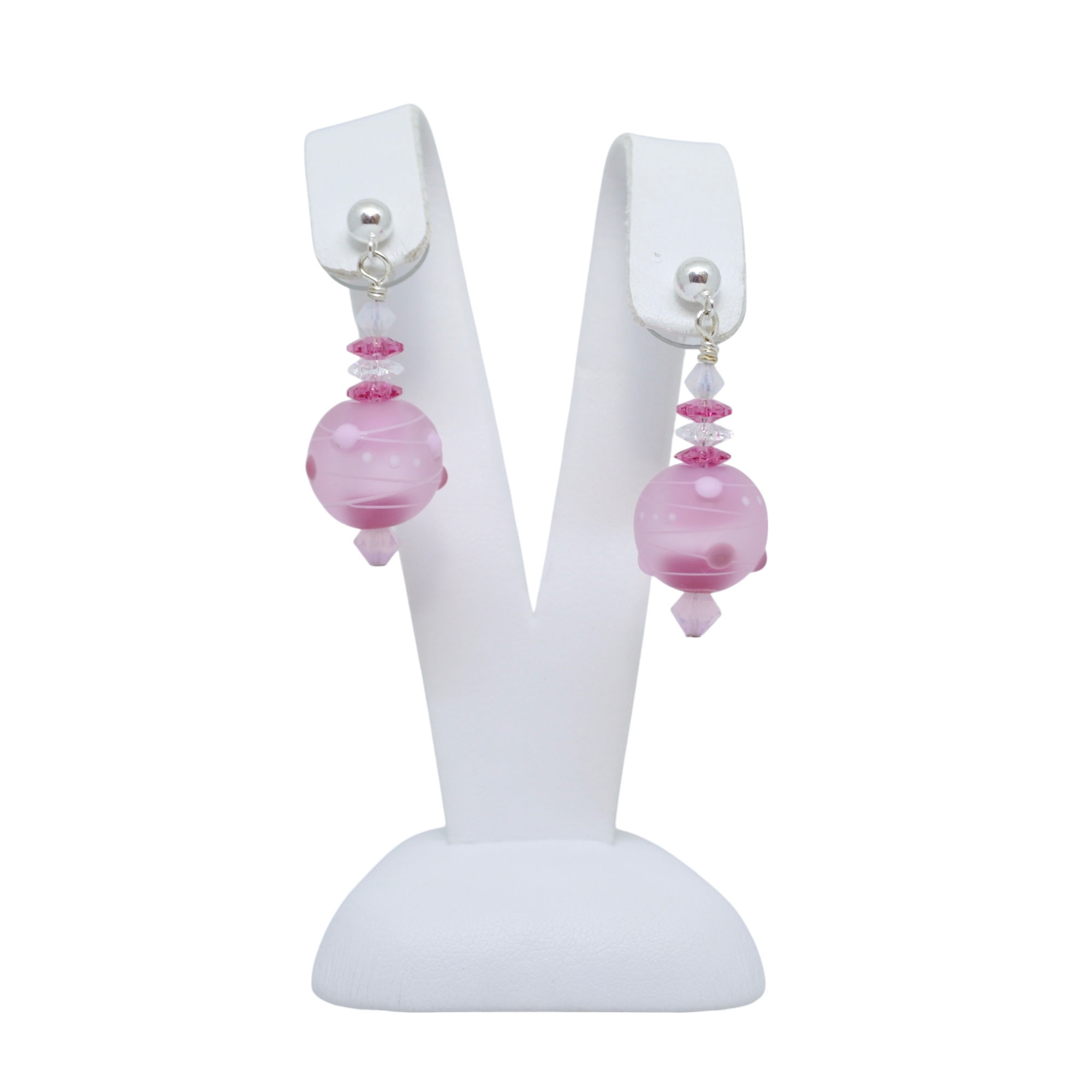 Pink lampwork earrings on earring display