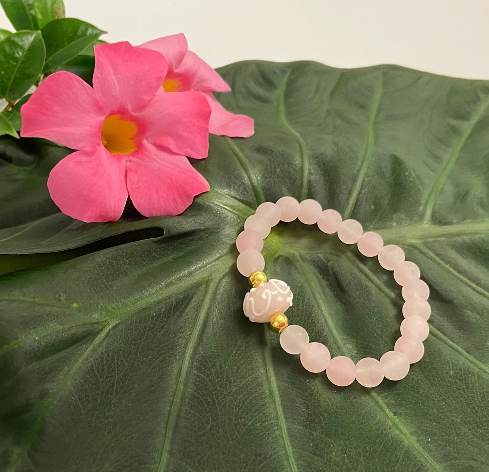 Thumbnail: gemstone and lampwork bead bracelet on a green leaf near mandevilla flowers