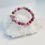 Thumbnail: gemstone and lampwork bead bracelet laying on a large crystal