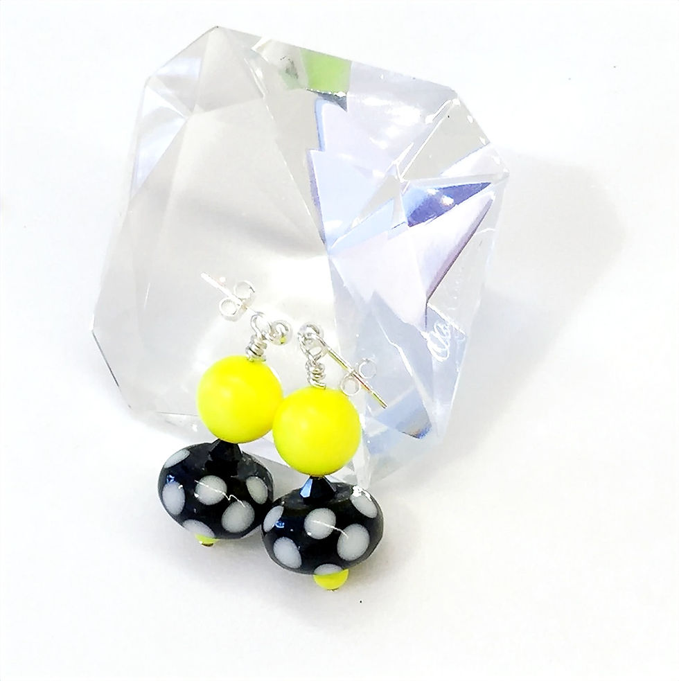 retro neon yellow lampwork glass earrings on a large diamond