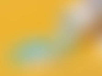 Spilled pill bottle with green, blue, and white pills on a bright yellow background. Some pills show imprinted text.