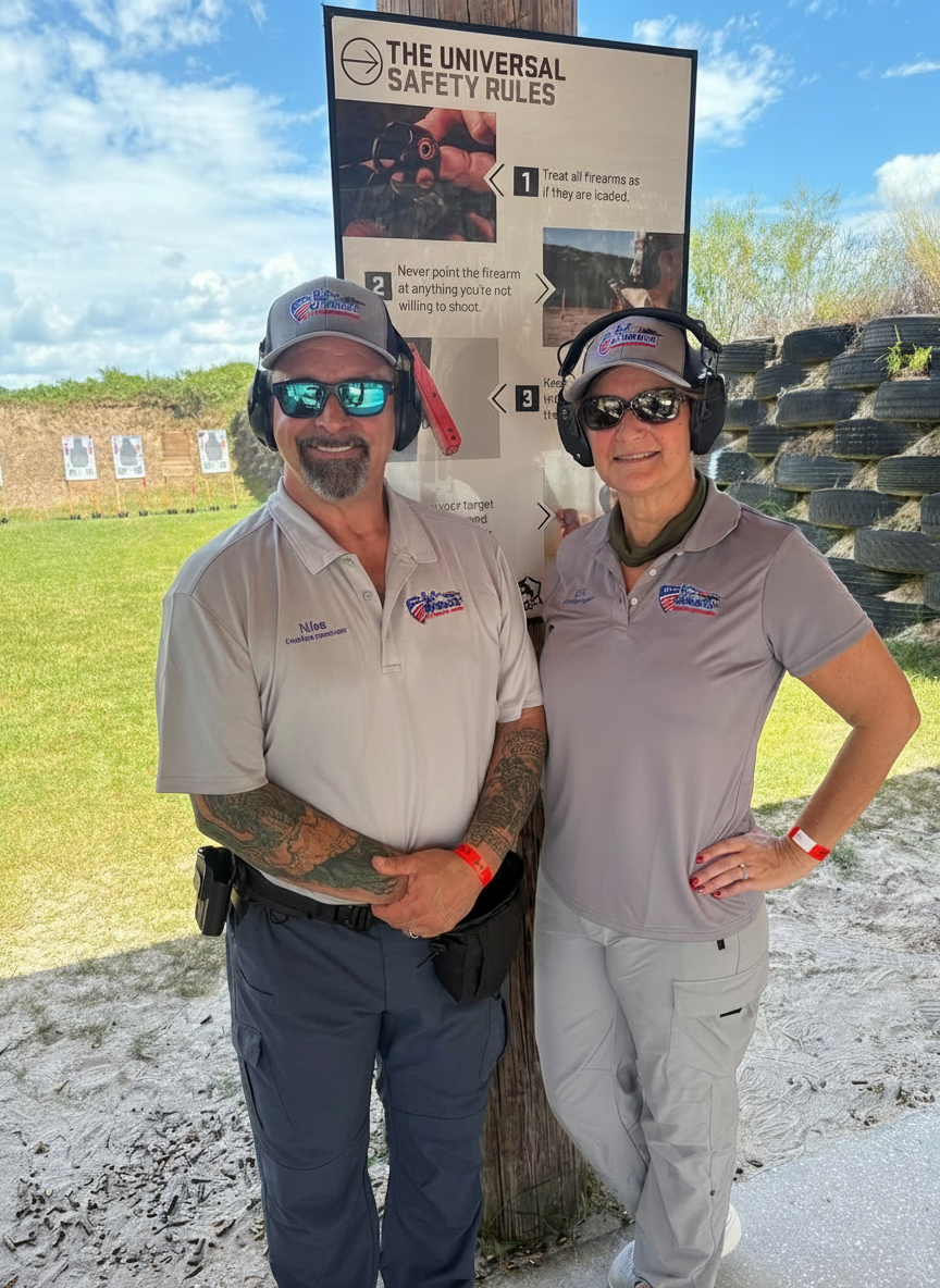 Two firearms instructors standing together at an outdoor range in branded MPower shirts and hats