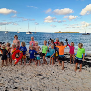 Kids from nine sailing boats gathered on the beach in the BVI on Christmas 2023, part of the sailing tribe who was our community for nine months.