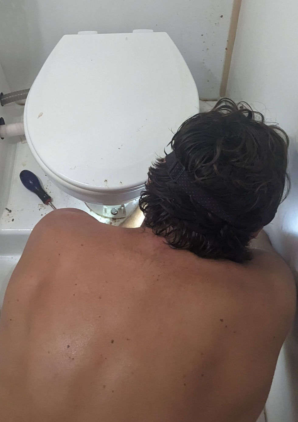 fixing the toilet on the boat