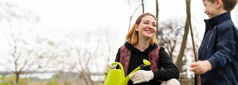 A women and child volunteering in the community gardens