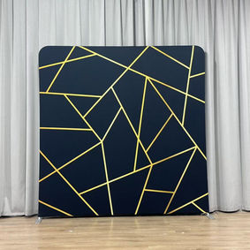 A black photo booth backdrop with intersecting gold geometric lines for a sleek and modern design.