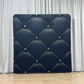 A black photo booth backdrop with a gold diamond tuft pattern, giving a luxurious quilted effect perfect for elegant events.