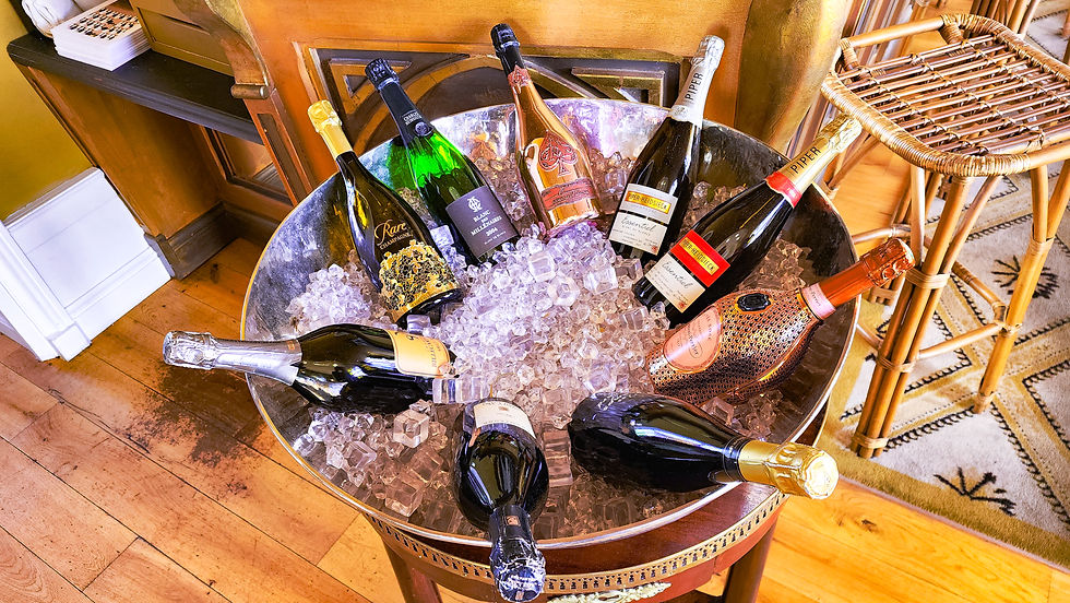 Bottles of champagne lying in a bucket full of ice at the Chateau de Sacy hotel in Sacy Champagne France. Luxury blog. Travel Blog. Champagne Tours. Wine Tours.