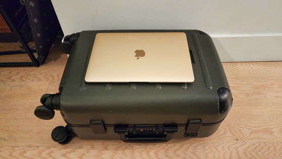Size comparison between a 12 inch MacBook Air and the small Solgaard carry-on closet in Best carry-on in 2024, Away, Solgaard, Beis, Monos. Best travel blog. best blog. Luxury travel blog.