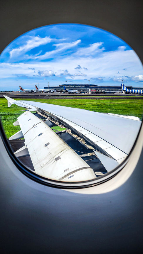 Flaps and spoilers extended on the wing from Emirates A380 in Business Class. Flight review. Luxury travel. First Class. Best travel blog.