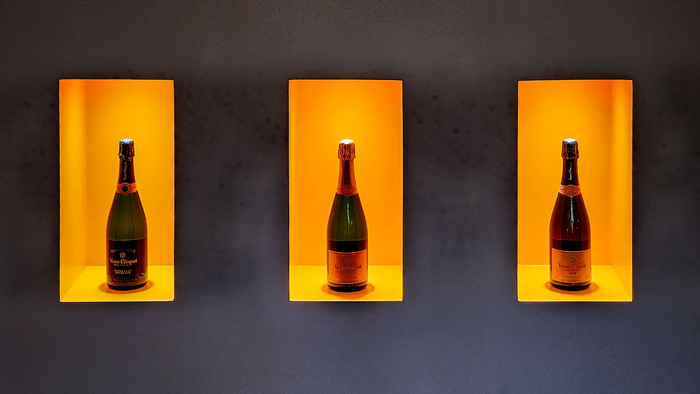 Bottles of champagne beautifully displayed at Veuve Clicquot in Reims Champagne France. Luxury Wine Travel Blog.