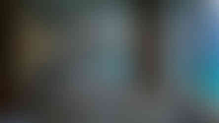 Bathroom with a marble bathtub, modern hanging light, and floor-to-ceiling windows offering a view of the ocean at the Ritz Carlton Maldives—discover more stunning destinations like this on Elegant Escape, the best luxury travel blog.