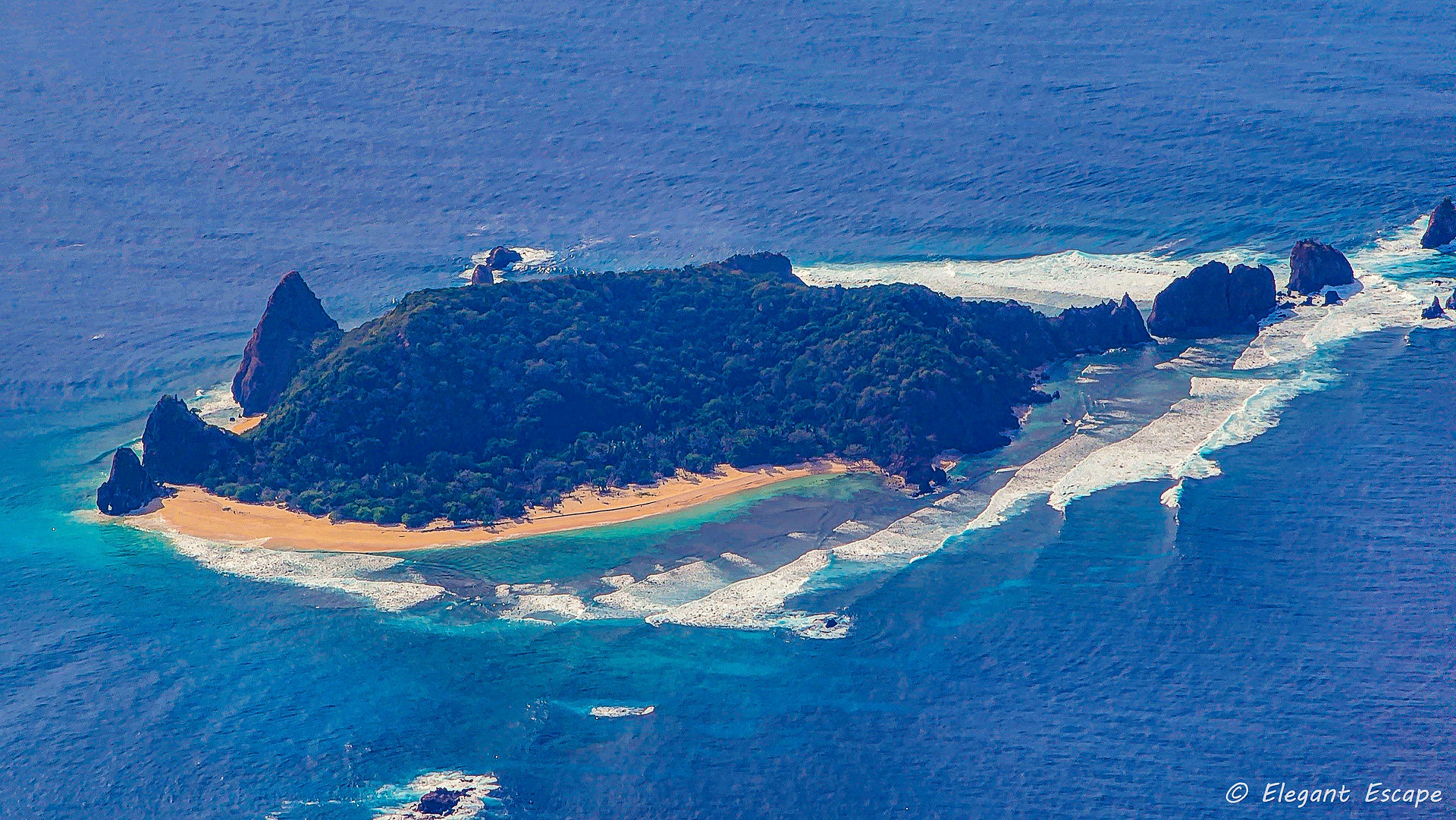 View of island that looks like a shark with beautiful sand beach and surf in descent into Coron, El Nido or Coron Philippines travel blog suggestion. Best travel Blog. Luxury Travel. Travel Reviews. Best Blog.
