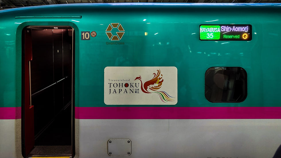 The green and pink Gran Class bullet train, adorned with the “TOHOKU JAPAN” logo, proudly heads for Shin-Aomori on the renowned “Hayabusa” service. As featured in Elegant Escape, the best luxury travel blog, this journey offers an exquisite experience blending speed and comfort.