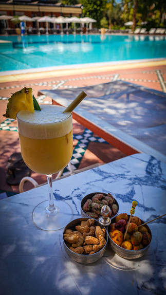 Pina colada like cocktail called coco loco in the pool area at La Mamounia hotel in Marrakesh Morocco. One of the Best hotel in the world. Luxury hotel review travel blog.