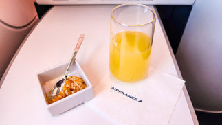 Orange juice Mimosa Business class seat Air France A350 with full recline lay flat seat and extra legroom. Luxury flight. Luxury Travel Blog.