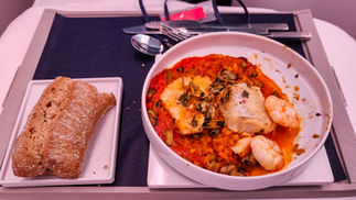 Delicious sea food mix meal Business class seat Air France A350 with full recline lay flat seat and extra legroom. Luxury flight. Luxury Travel Blog.