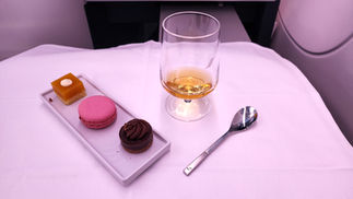 Macaroon port wine and dessert Business class seat Air France A350 with full recline lay flat seat and extra legroom. Luxury flight. Luxury Travel Blog.