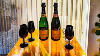 Glasses and bottles of vintage champagne at the tasting Champagne tour of Champagne Veuve Clicquot in Reims Champagne France. Luxury Wine Travel Blog.