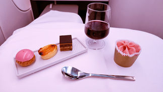 Cake dessert and sherry wine Business class seat Air France A350 with full recline lay flat seat and extra legroom. Luxury flight. Luxury Travel Blog.