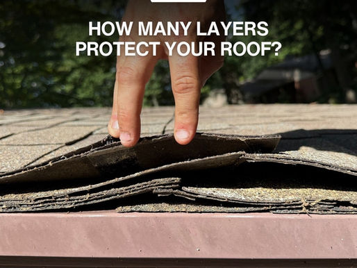 Hand lifting asphalt shingles at a roof edge to reveal underlying layers, with Miami Valley Roofing & Restoration branding.