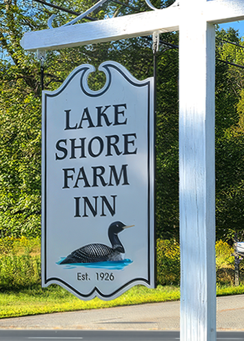 Lake Shore Farm Inn entrance sign in Northwood, NH featuring the inn name, loon illustration, and established date of 1926.