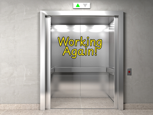 An elevator with open doors and a sign saying "Working Again!"