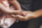 caucasian-parent-holding-his-newborn-daughter-feet-hand-while-she-is-sleeping.jpg