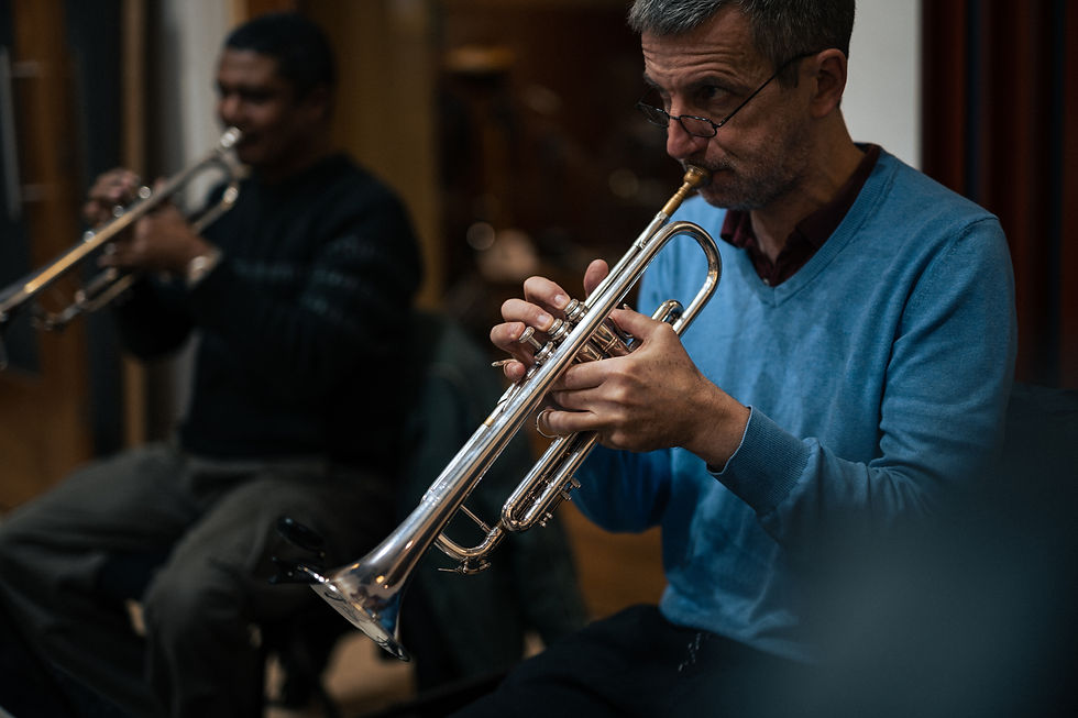Two men are playing the trumpet.