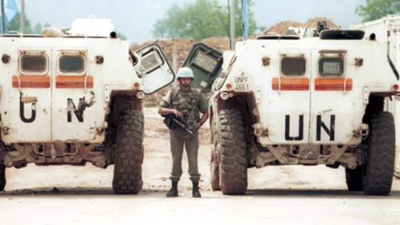 A French UN peacekeeper poses next to 2 VAB armored personnel carriers in Sarajevo, 1994.