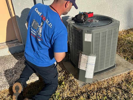 HVAC technician checking refrigerant levels for AC not cooling problem