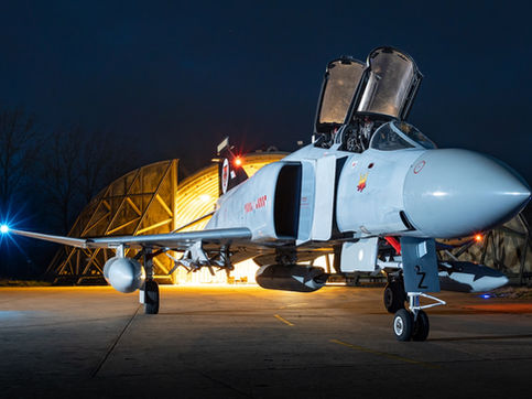 The iconic McDonnell Douglas F-4 Phantom II fighter aircraft at night. 