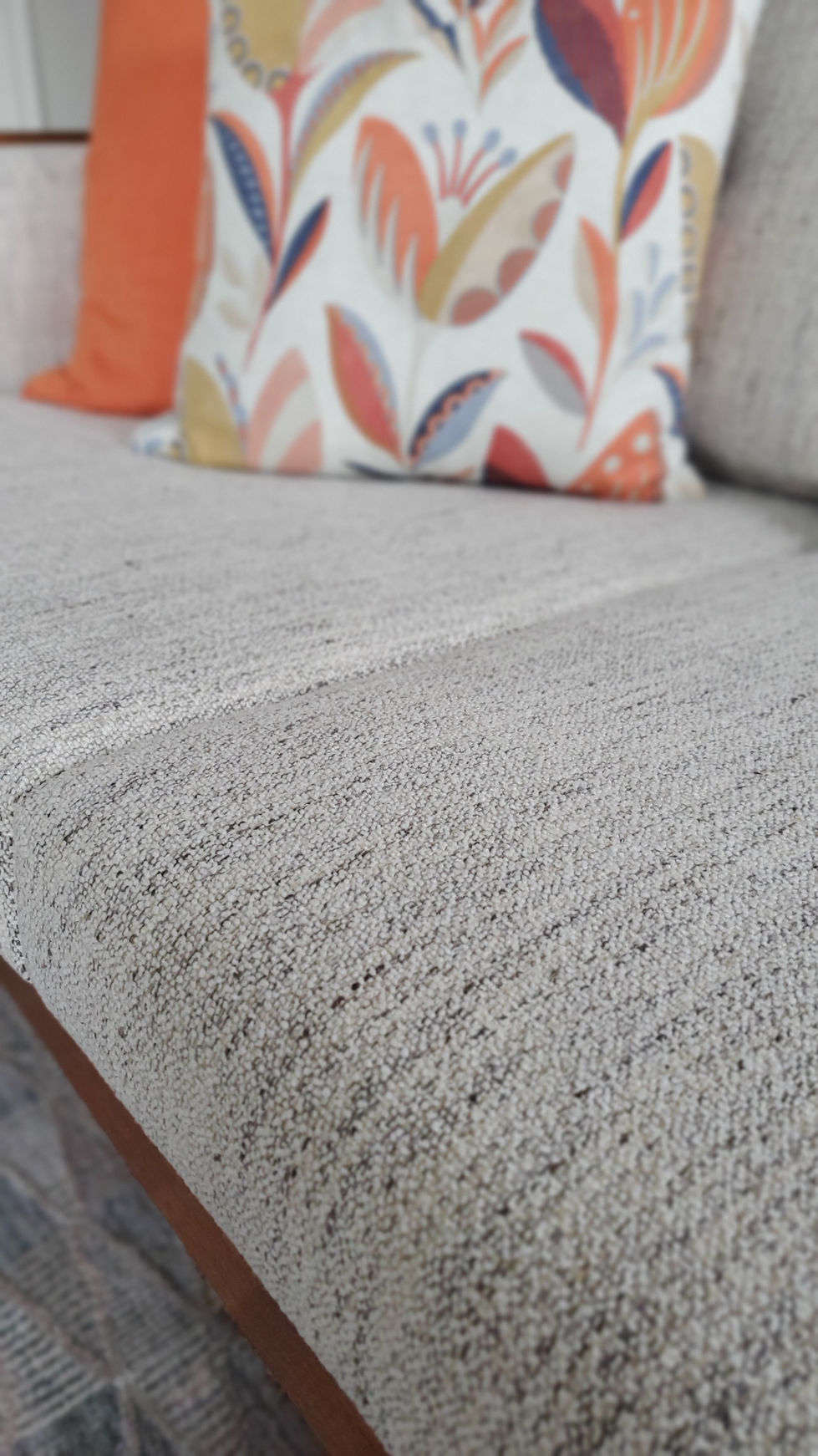 Teak furniture reupholstery with new fabric on sofa and custom toss pillows