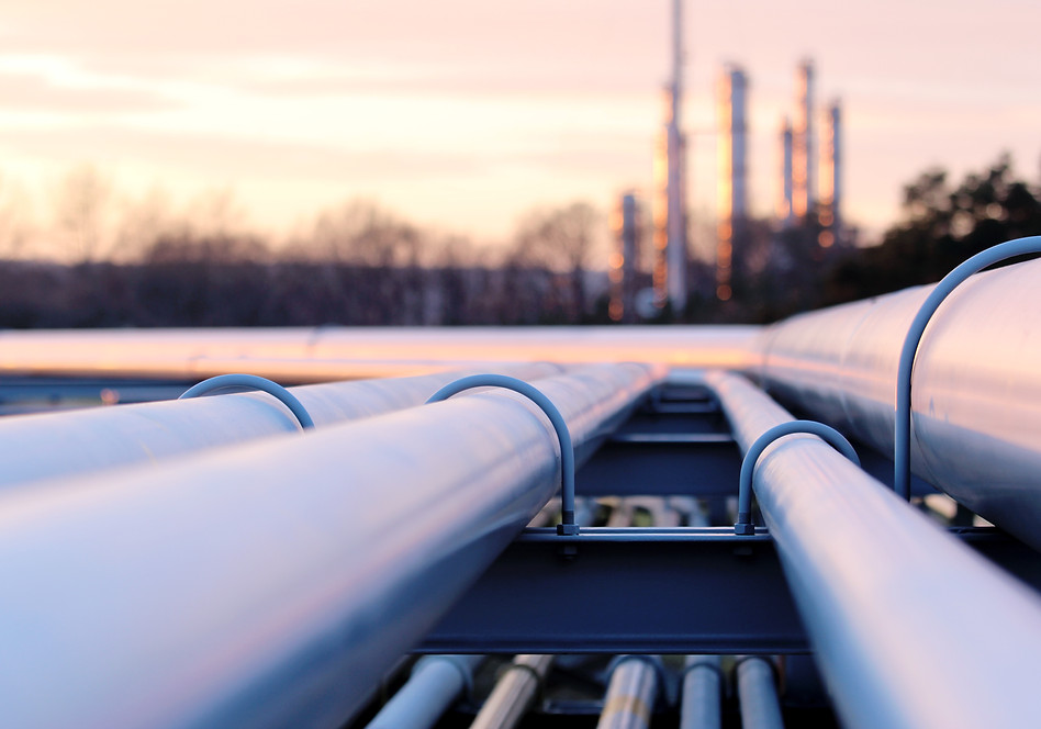 steel long pipes in crude oil factory during sunset
